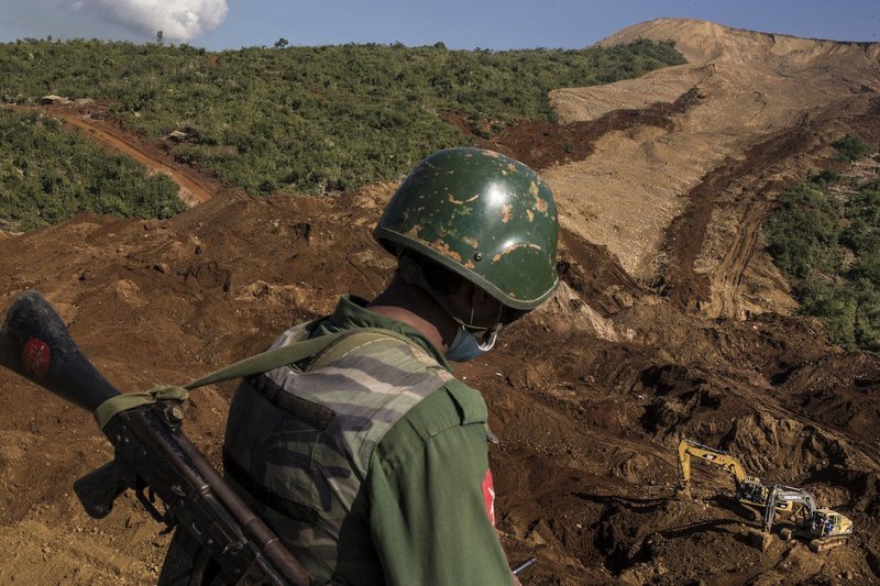 A Myanmar army soldier surveys site where a deadly landslide in jade mine had buried over a hundred people days before in Hpakant, Kachin State, November 2015