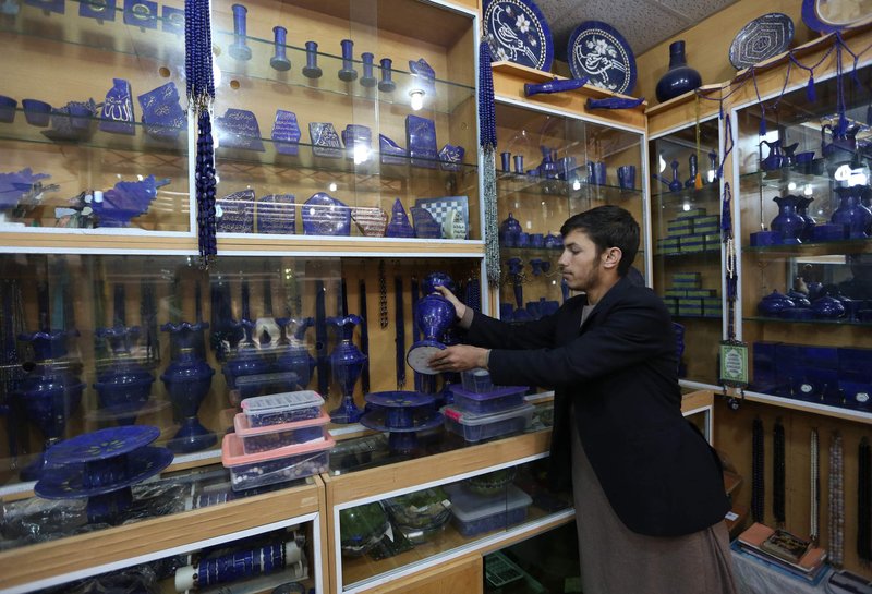 An Afghan lapis lazuli shopkeeper waits for customers