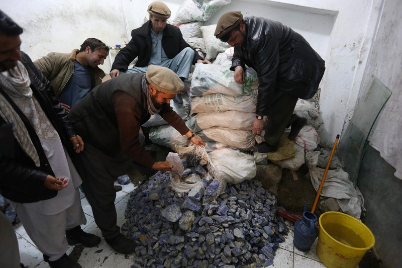 Afghan businessmen check lapis lazuli in the city of Kabul, Afghanistan