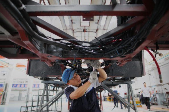 A Chinese worker assembles a hybrid bus at a factory on September 11, 2009 in Beijing, China. Feng Li / Getty Image