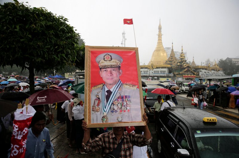 A man holds the portrait of military commander-in-chief Senior General Min Aung Hlaing during a rally to denounce the US sanctions imposed on senior Myanmar military officials, in Yangon, Myanmar, 3 August 2019.