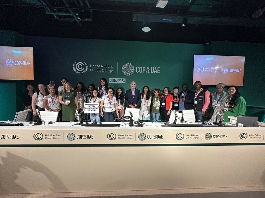 Activists, civil society and others pose for a photo after an event about land and environmental defenders co-organised by Global Witness at COP28 in Dubai, UAE, on 3 December 2023