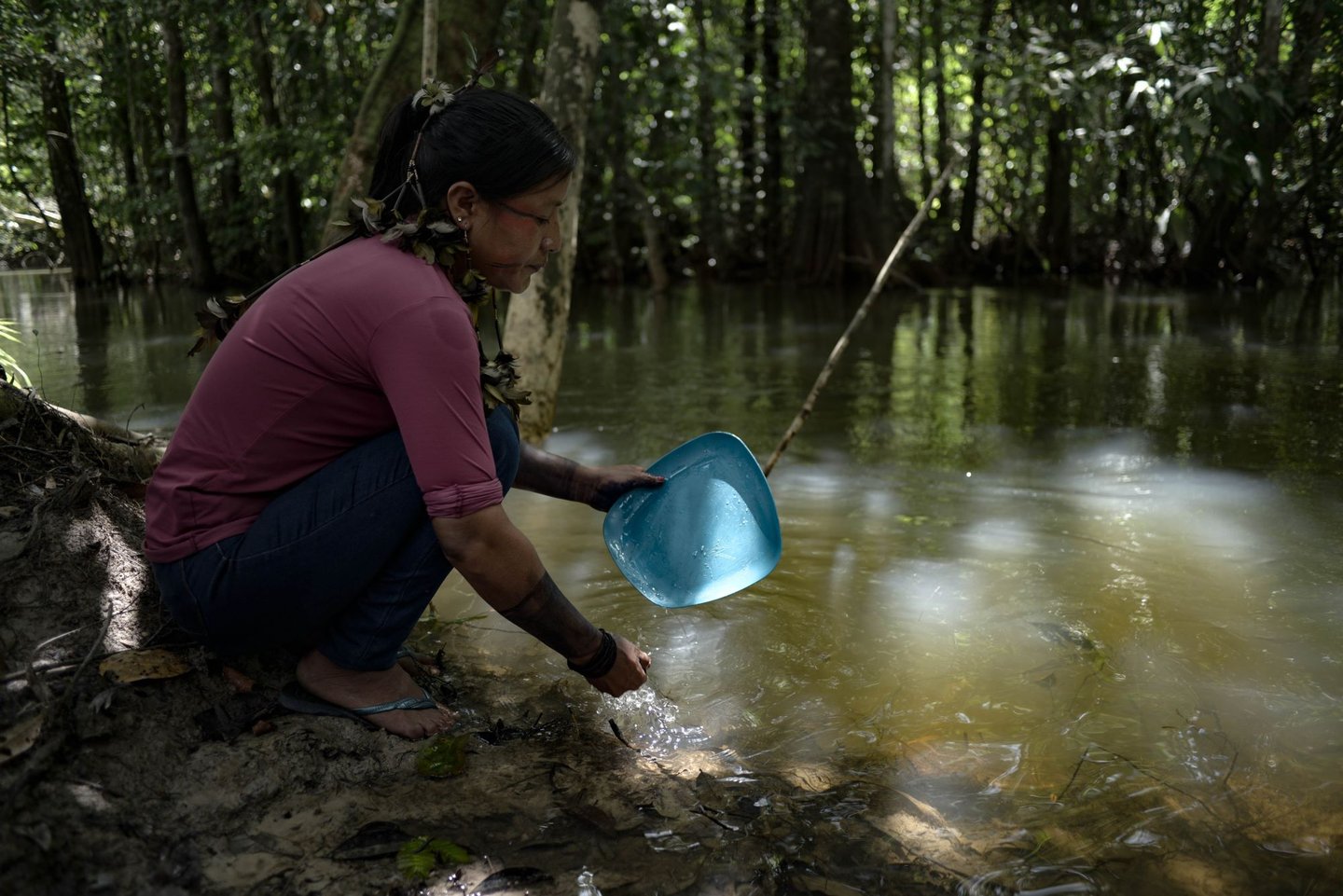 An Indigenous woman in Pará pauses by the river in Brazil