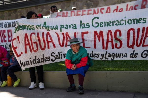 "Water is worth more than gold" reads the sign behind this protestor, who has joined a march against lithium extraction in Indigenous communities in San Salvador de Jujuy, Argentina. Rodrigo Abd / Associated Press / Alamy