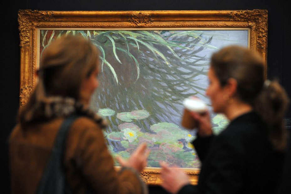 Art handlers adjust Le Palais Ducal Vu De Saint Georges Majeur by Claude Monet