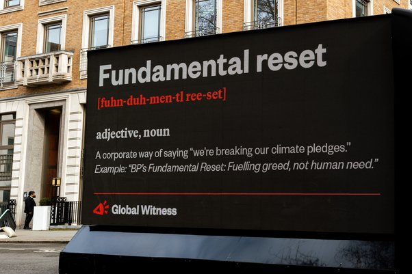 global witness billboard critiquing bp's reversal of green energy ambition