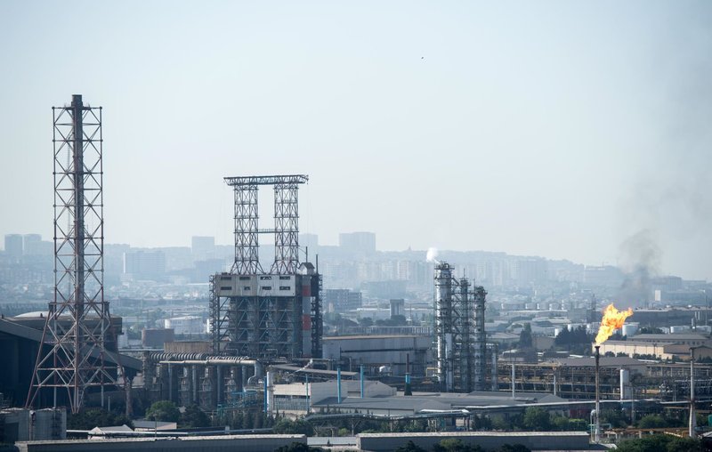 Pollution floats up over an industrial area of the Azerbaijani capital Baku. Bernd Thissen / dpa / Alamy