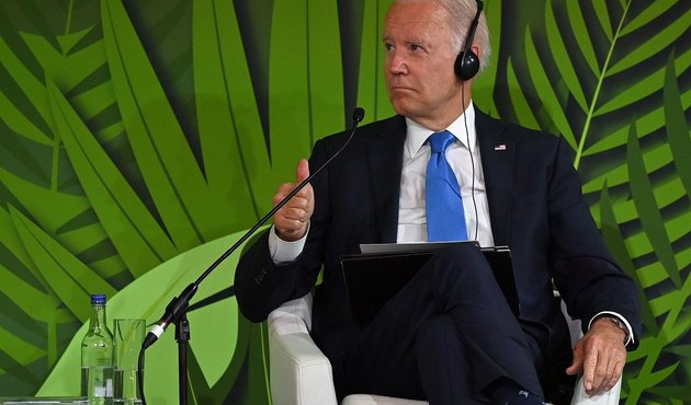 president biden sat in front of forest background