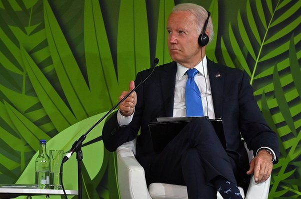 president biden sat in front of forest background