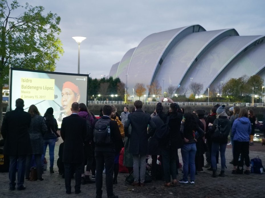 Projection in Glasgow commemorating the 1,005 Defenders who have been killed since the adoption of the 2015 Paris Agreement