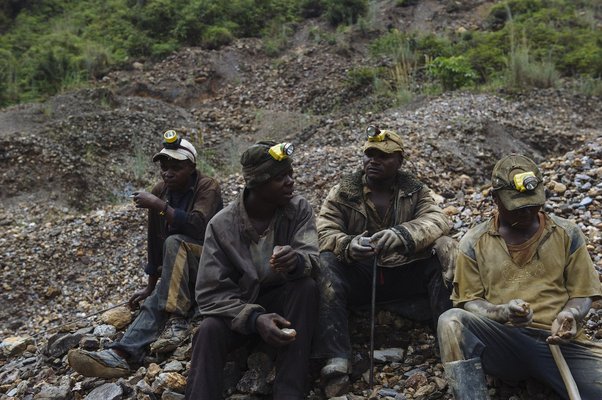 A group of artisanal miners sit at the D23 cassiterite mining site in South Kivu province in the east of the Democratic Republic of the Congo on April 4, 2015. Phil Moore / Global Witness