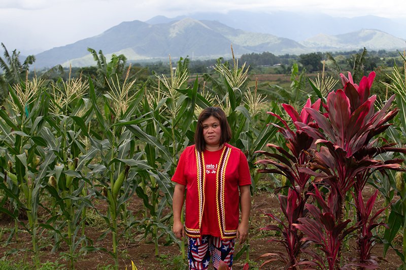 Activist from the Philippines, Cheryl Cagaanan, standing in field