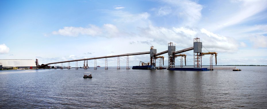 A conveyor belt feeding hoppers at a soy export terminal