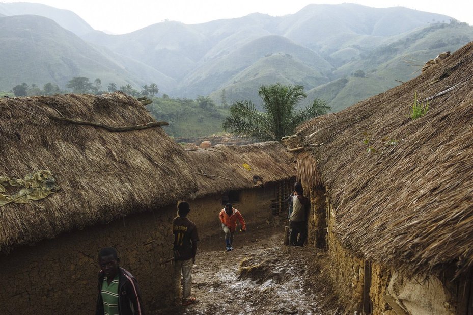 Men walking through the mining village of Mufa II in South Kivu, Democratic Republic of Congo.