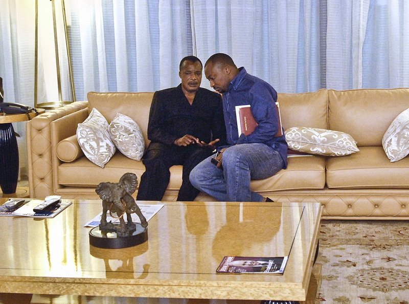 Denis Sassou-Nguesso (left), President of Republic of Congo, with his son Denis Christel Sassou-Nguesso (right) on plush sofa