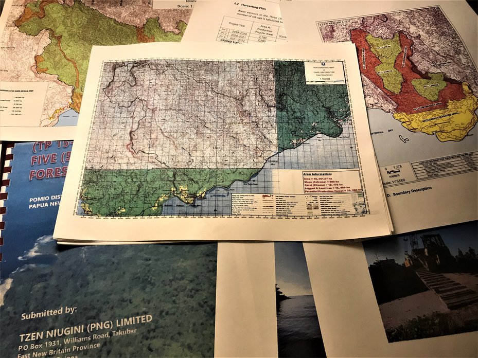 various maps and logging project documents from papua new guinea shown by employee of east new britain resources group