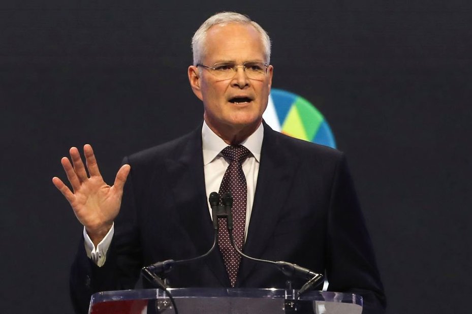 ExxonMobil CEO Darren Woods speaks during a talk