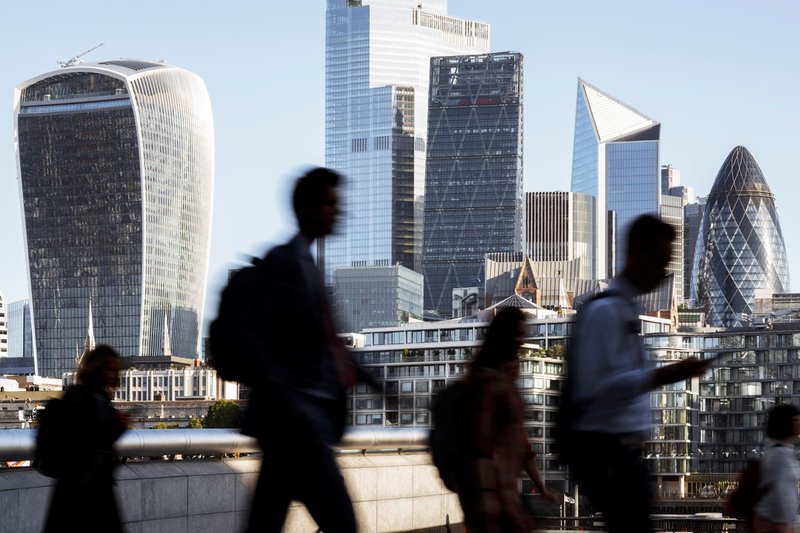 businessmen walk outside finance offices in london