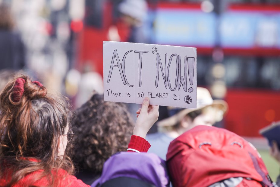 Climate activists at Fridays for Future march with "act now, there is no planet b" poster