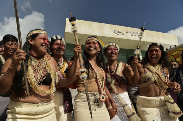 Nemonte Nemquimo (C), Waorani leader from Ecuador, celebrates with other Waorani indigenous people after a court ruled in their favour on the community's legal challenge to the government