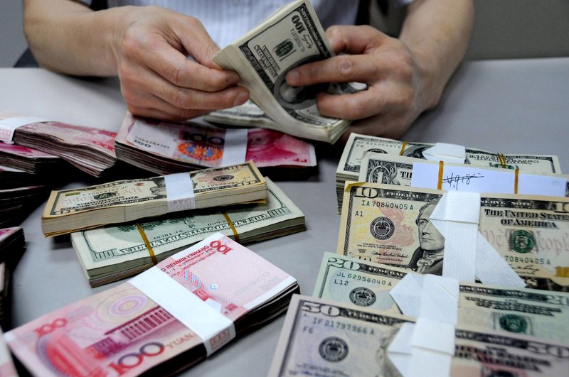 A staff member counts money at a branch of the Bank of China on August 10, 2011 in Lianyungang, Jiangsu Province of China.