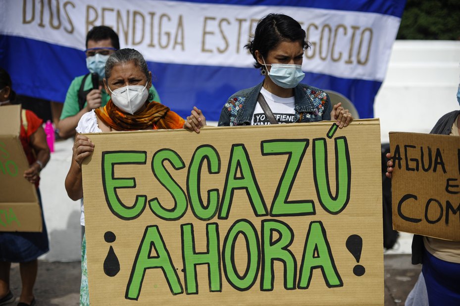 Women hold up a sign during a protest for the signing of the Escazú deal, El Salvador