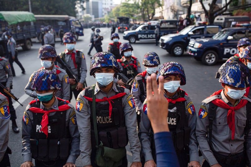 Riot police stand on guard in front of the Central Bank building during a demonstration in Myanmar, February 2021