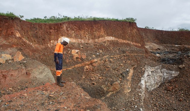 A worker inspects an open cast at Arcadia Lithium mine in Goromonzi, Zimbabwe