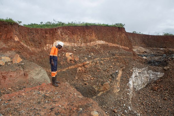 A worker inspects an open cast at Arcadia Lithium mine in Goromonzi, Zimbabwe