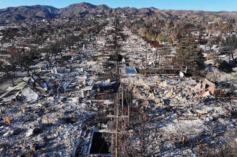 An aerial photograph of blackened buildings and scorched trees following the aftermath of the LA fires in January 2025.