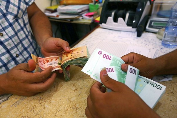 Currency is changed at a currency exchange in the Souk il-Jumaa district, Tripoli, Libya