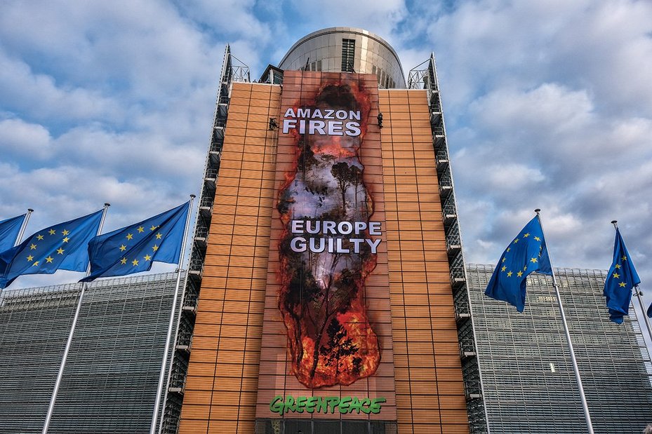 Greenpeace campaigners cover the EU Commission’s headquarters with giant image of Amazon fires