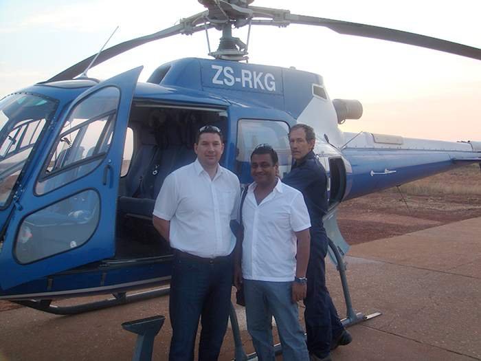 Andrew Groves and Solanki in front of helicoptor in Zanzibar