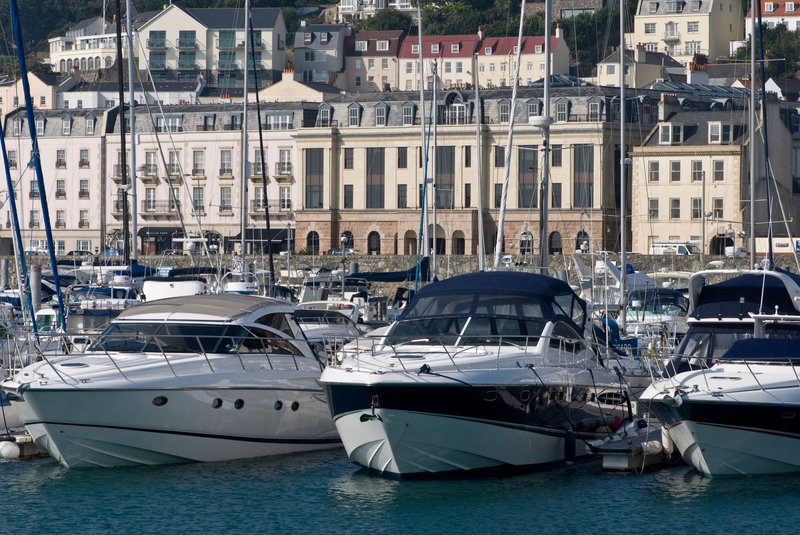 Financial centre and motor boats in marina, St Peter Port, Guernsey.