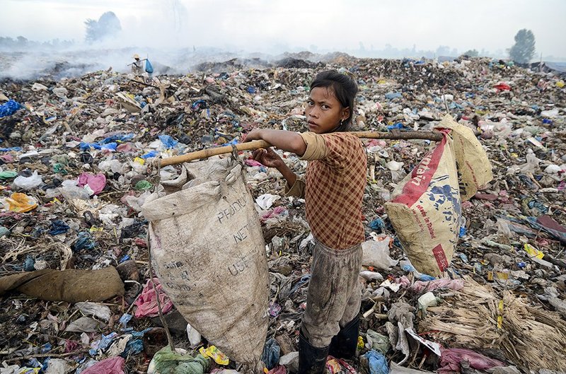 A child collecting recyclable rubbish at a dump in Siem Riep