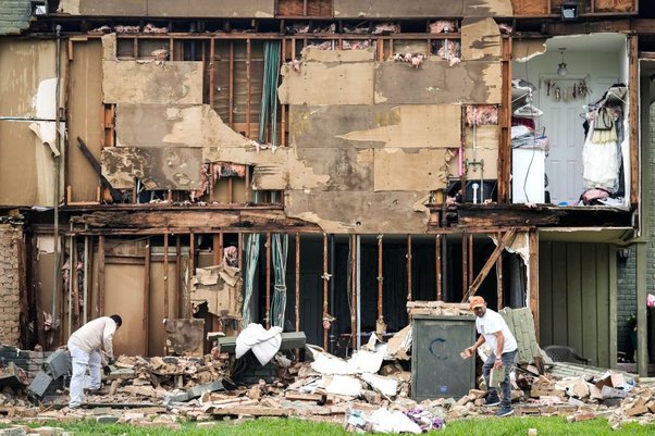 Crews work to clean up debris after a wall came down in the aftermath of a severe storm on Friday, May 17, 2024 in Houston