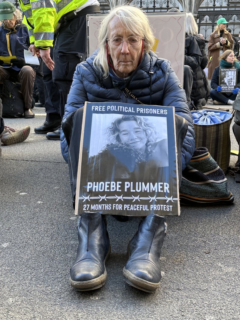 woman protests sentencing of phoebe plummer, climate protestor from UK