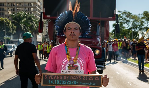 Indigenous people holding a sign at the Acampamento Terra Livre (Free Land Camp) in Brasilia, Brazil