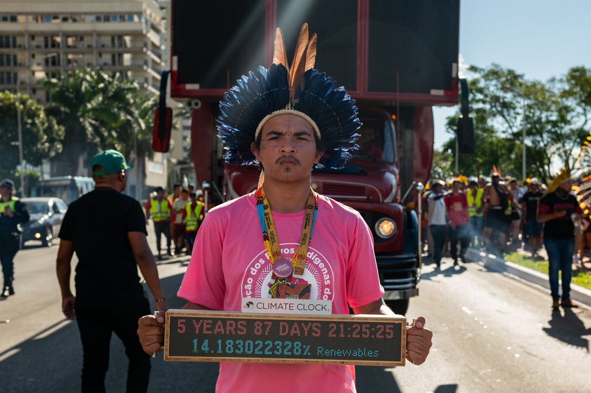 Indigenous people holding a sign at the Acampamento Terra Livre (Free Land Camp) in Brasilia, Brazil