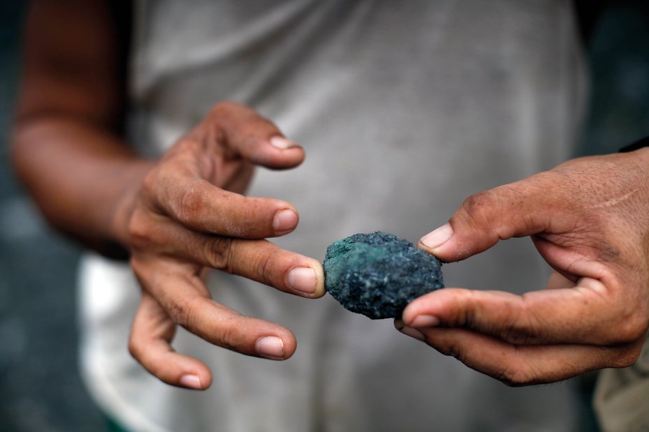 A jade miner holds a freshly mined piece of jade, in Lone Khin town, Hpakant, Myanmar