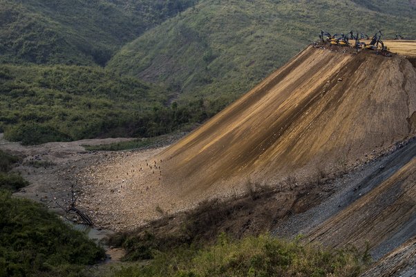 Miners work at the foot of a jade mountain in Myanmar