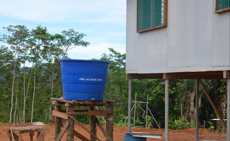 A blue Joinland Group water tank adorns a house gifted to a community leader in Papua New Guinea