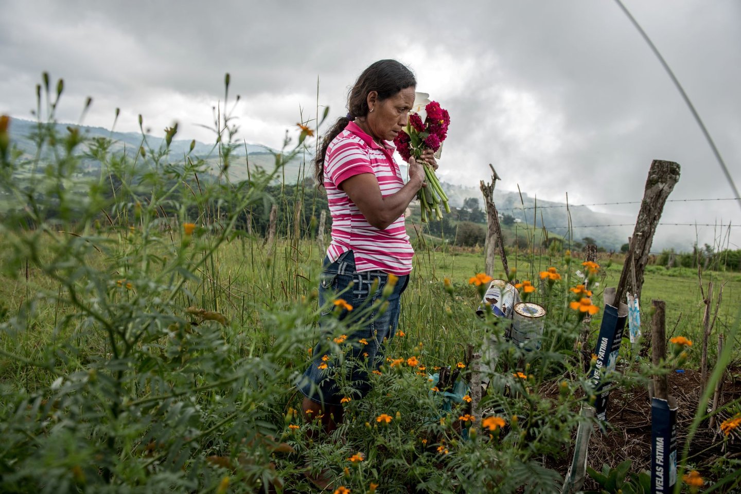 Julia Francisco Martínez stands at the graveside of her husband Francisco Martinez Marquez