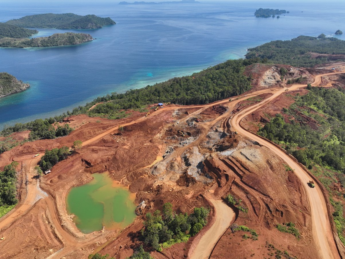 Image from above showing nickel mining site with destroyed rainforest on tropical island of Kawe in Raja Ampat, West Papua, Indonesia
