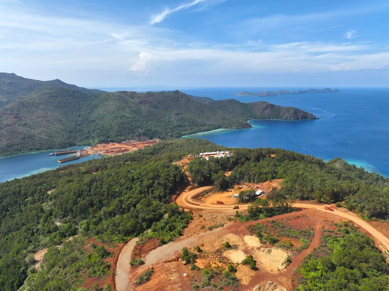A view from above of the nickel mining on Kawe showing the brown areas of mining deforestation close to the narrow central part of the island