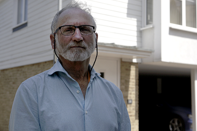 photo of leaseholder outside his house