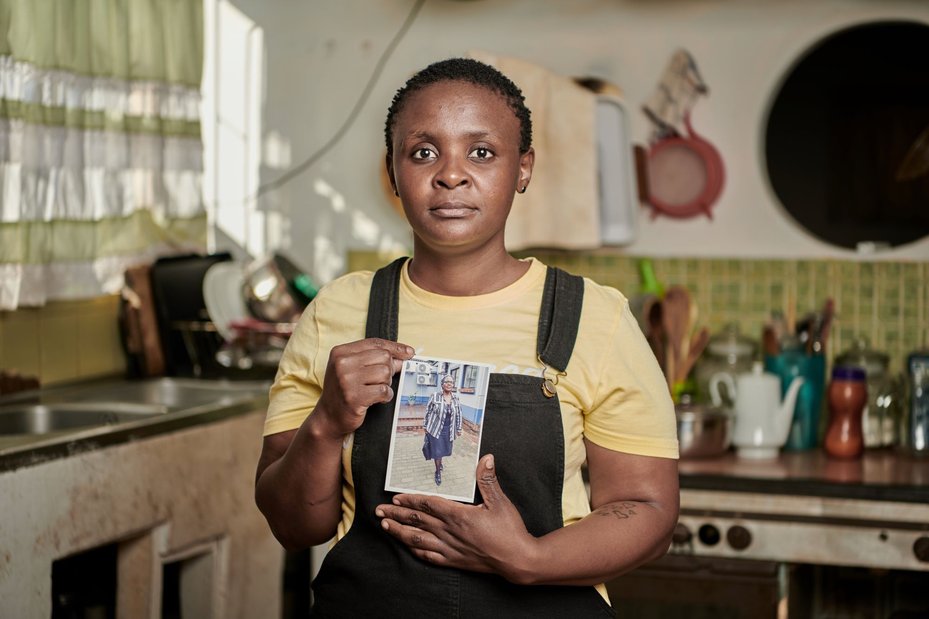 Malungelo Xhakaza holds a photograph of her mother, Fikile Ntshangase, who was killed in 2020 after opposing the expansion of a coal mine bordering the community of Somkhele, South Africa