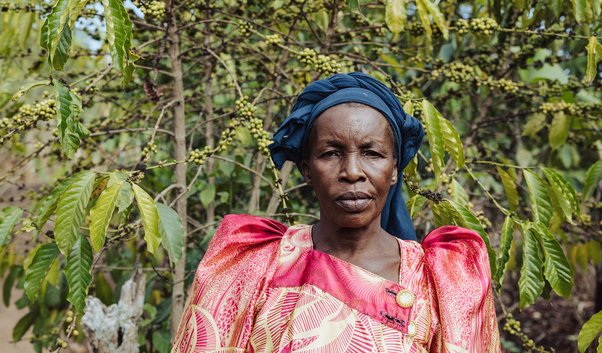 Mariam Najjagwe standing in front of her crops.