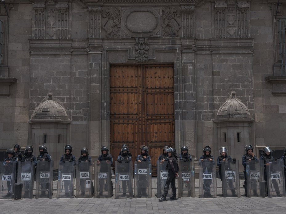 Mexican police stand guard at a protest