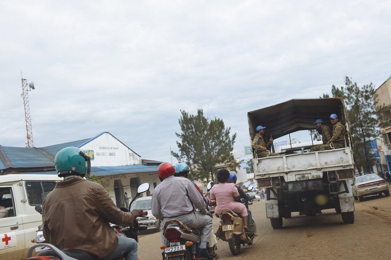 Motorcycle taxis follow a United Nations peace-keepers' lorry down a main boulevard in Bukavu, South Kivu province, in the east of the Democratic Republic of the Congo on April 2, 2015